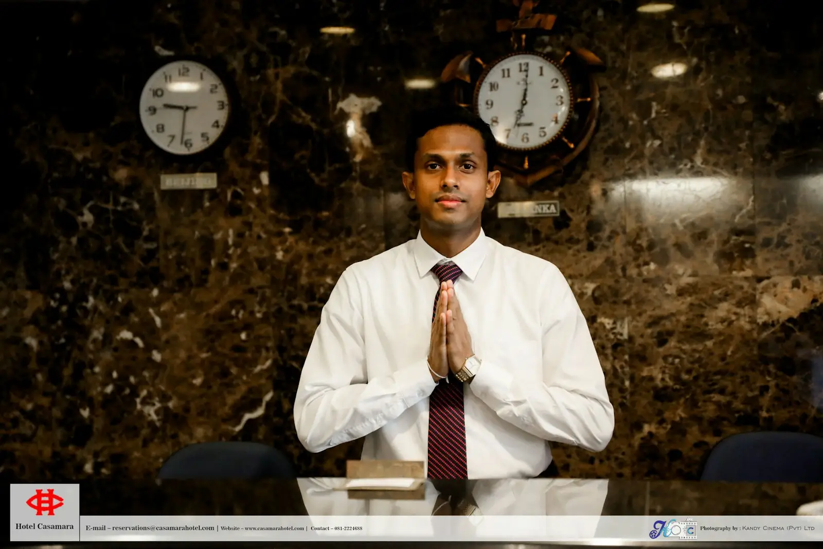 A hotel receptionist greeting guests at the front desk