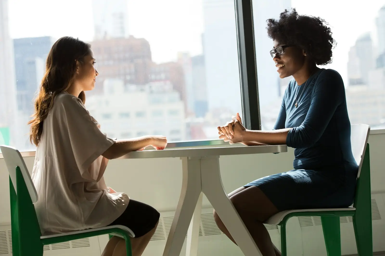 A recruiter talking with a candidate at a table